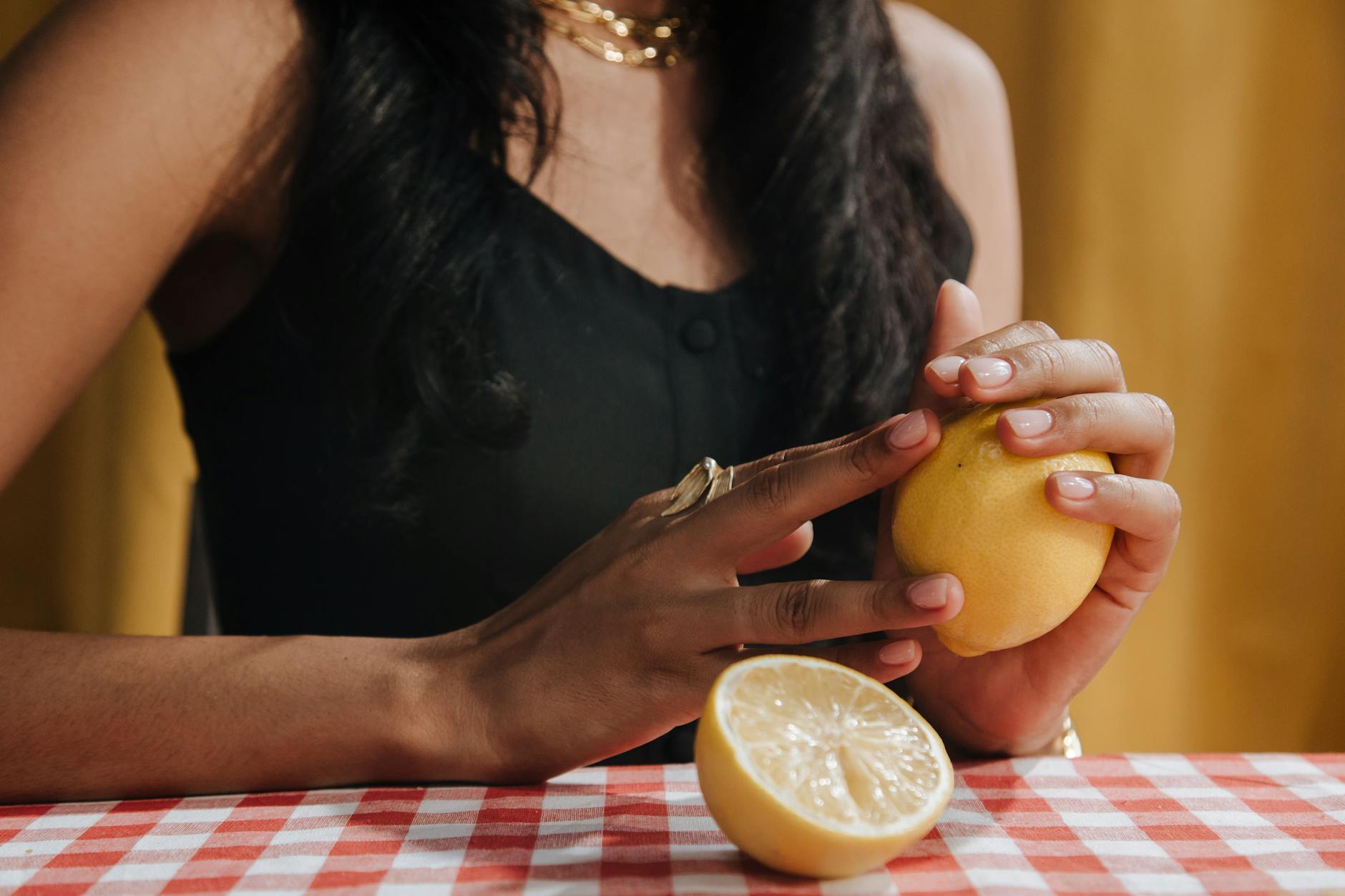 Woman holding colorful silicone vibrators in contemplative moment