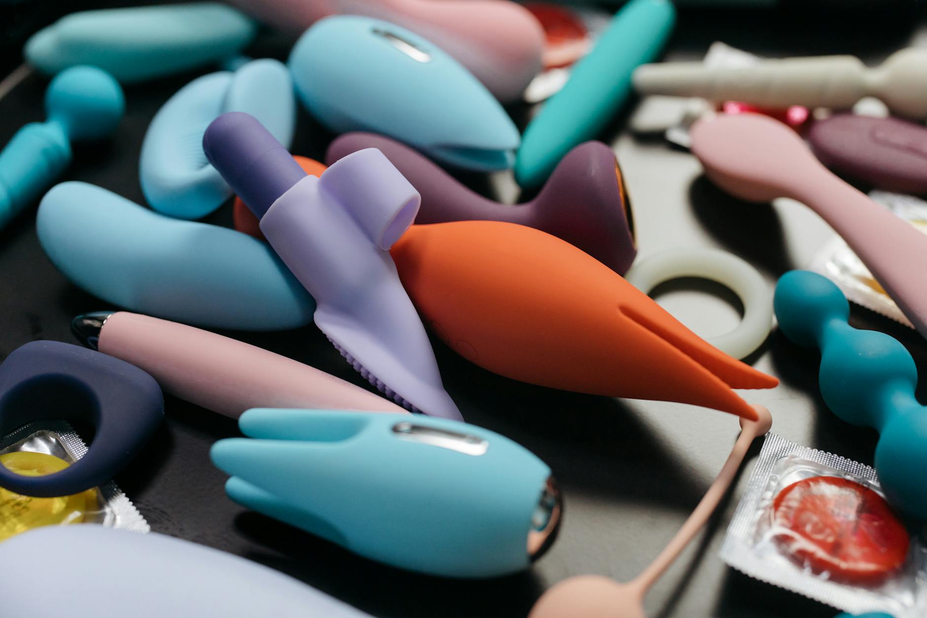 Collection of colorful clitoral vibrators and intimate wellness toys displayed together